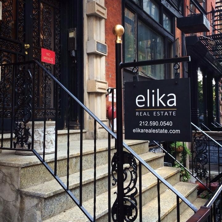 ELIKA Real Estate sign beside the stoop of the firm's former Bond Street office in New York City.