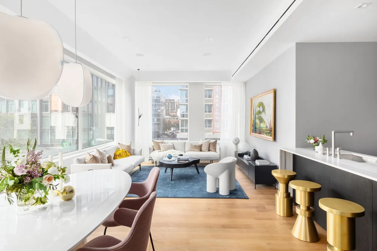 Bright apartment interior with an open kitchen, dining area and living room